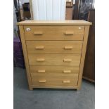 A modern 5 drawer chest.