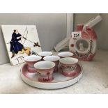 A modern Japanese saki set with 6 cups with pictures to base & a painted tile featuring Japanese