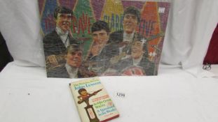 A Dave Clark Five jigsaw puzzle (2 pieces missing) and a John Lennon 'In His Own Words.