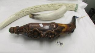 A resin decorative elephant tusk, a decorative drinking flask and a horn,