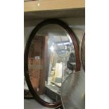 2 oval framed bevel edged mirrors.