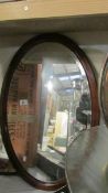 2 oval framed bevel edged mirrors.