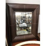 A large leather surround mirror