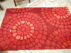 A good quality rug in red, 183 x 122cm.