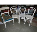 3 bent wood chairs and a white painted chair.