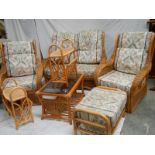 A cane/whicker 7 piece suite with cushions.
