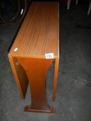 A teak effect drop side table in good condition, 120 x 75 cm.