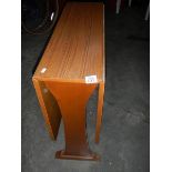 A teak effect drop side table in good condition, 120 x 75 cm.