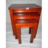 A nest of 3 mahogany tables in good condition.