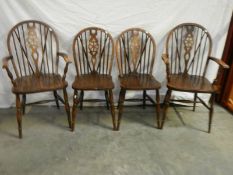 A set of 4 oak wheel back chairs,.