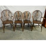 A set of 4 oak wheel back chairs,.