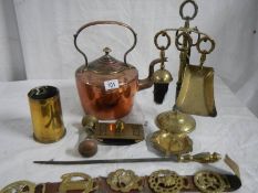 A Victorian copper kettles, a companion set, a gun shell, a horse brass and an old brass blotter.