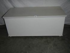 A large painted blanket box on wheels. 108 x 50 x 48 cm.