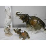 A large Royal Dux elephant (35 cm tall), a small Royal Dux elephant and a Royal Dux parrot, all a/f,