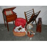 A sewing box on legs, an oak magazine rack, an old leather briefcase and 2 wicker sewing baskets.