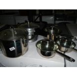 A quality 4 pan stainless steel set with lids and an aluminium pressure cooker.