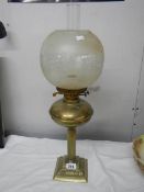 A brass oil lamp on cast base with reeded column, brass font complete with burner,