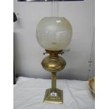 A brass oil lamp on cast base with reeded column, brass font complete with burner,