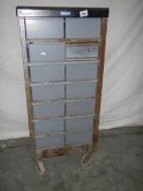 A 14 drawer metal chest on wheels, 105 x 48 x 46 cm.