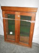 A glass fronted 2 door cabinet with shelves (glass needs replacing) 115 x 98 x 30 cm.