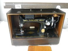 A cased Singer sewing machine in excellent condition.