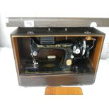 A cased Singer sewing machine in excellent condition.