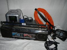 A JVC stereo radio cassette recorder, a hand light, an alarm clock radio and an extension lead.