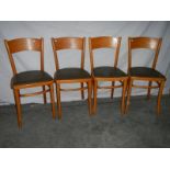 4 fine ash bentwood chairs with green vinyl seats.