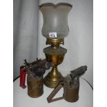 An old brass oil lamp complete with chimney.