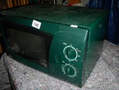 An LG microwave oven in green, in good condition.