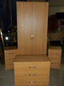 A 4 piece bedroom suite comprising wardrobe and 3 x 3 drawer chests.