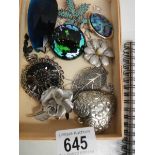 A mixed lot of costume brooches etc.