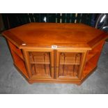 A string inlaid mahogany TV cabinet with glass doors.