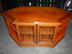 A string inlaid mahogany TV cabinet with glass doors.