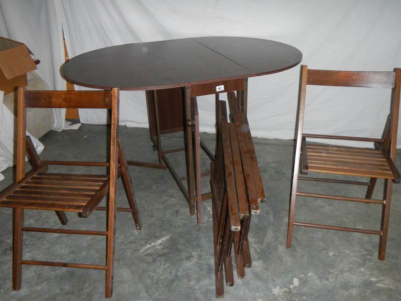 A good fold out oak veneer table with 4 folding chairs inside, 135 x 97 x 74 when open.