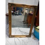 A gilt framed bevel edged mirror, 75 x 106 cm.