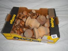 A large box of mainly pine knobs and legs, most with screws.