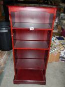 A slim mahogany bookcase.