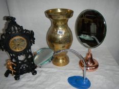 A large brass vase, a bevelled mirror, a magnifying glass, a painted clock etc.