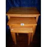 A nest of 3 pine tables in good condition.