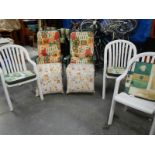 2 folding garden chairs and 3 white garden chairs.