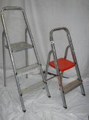 A two step and a three step aluminium ladder.