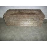 A concrete planter 61 x 28 cm x 22 cm high,