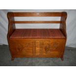 A pine cushioned settee with carved flowers, 45 x 100 x 83 cm,