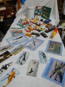 A mixed lot of die cast models and aircraft photographs.