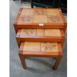 A nest of 3 tiled top tables in good condition.