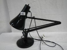 An anglepoise reading lamp in black.