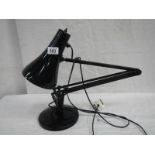 An anglepoise reading lamp in black.