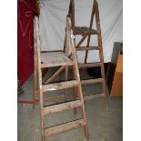 2 old wooden step ladders.