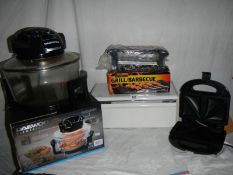 A Daewoo infra red cooker, an electric barbecue grill and a sandwich toaster.